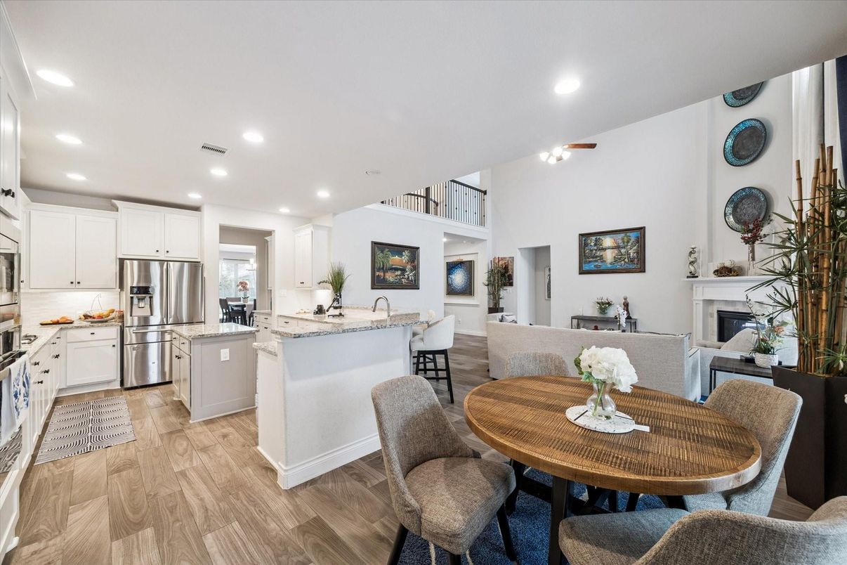 Dining room, Fireplace, Interior, Kitchen, Living room, Recessed Lighting, Stainless Steel Appliances, Wood Texture Flooring