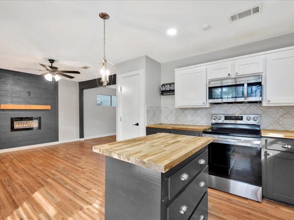 Fireplace, Interior, Kitchen, Pendant Lights, Recessed Lighting, Stainless Steel Appliances, Wood Texture Flooring