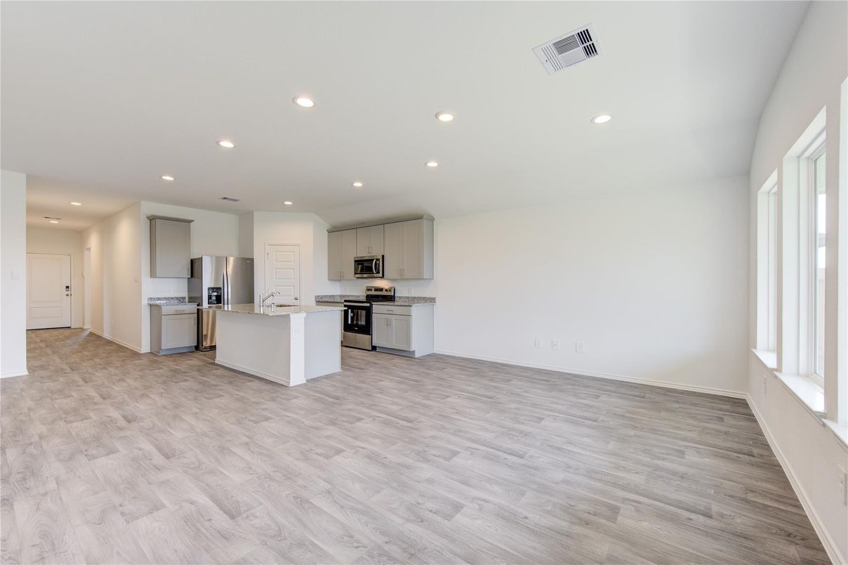 Empty room, Interior, Kitchen, Recessed Lighting, Stainless Steel Appliances, Wood Texture Flooring