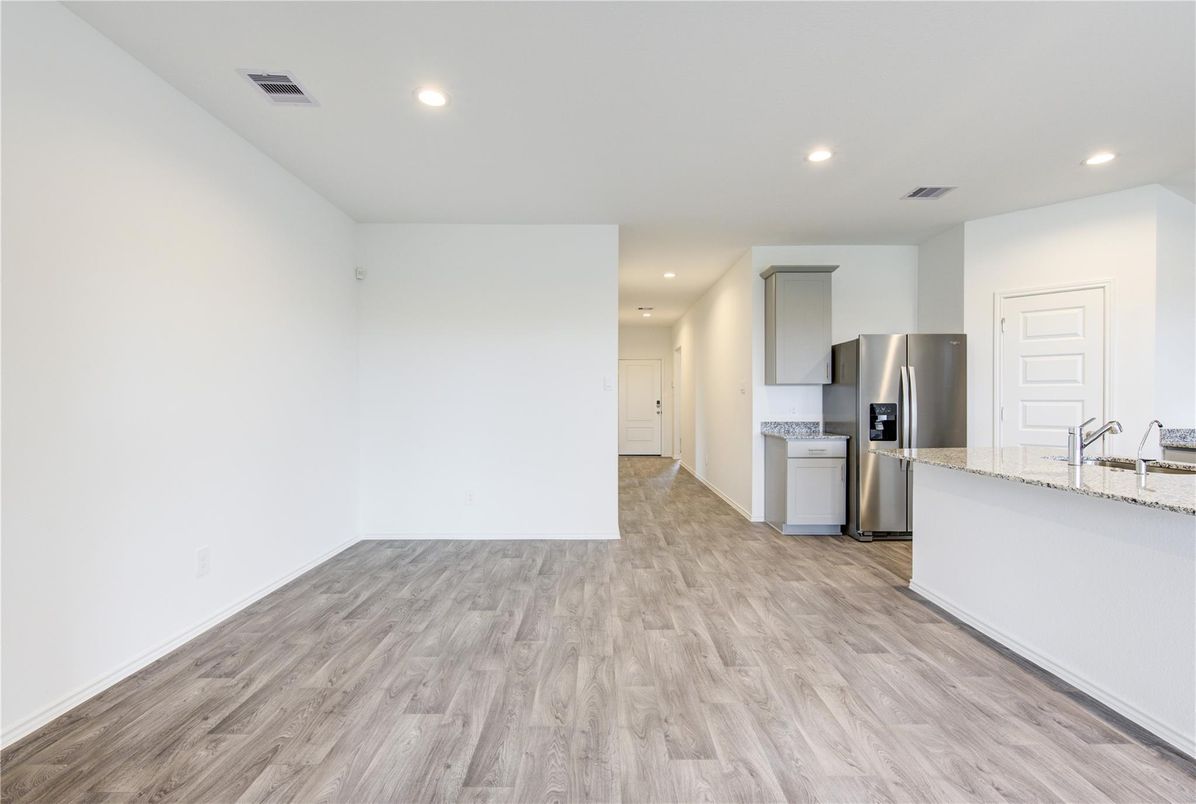 Empty room, Interior, Kitchen, Recessed Lighting, Stainless Steel Appliances, Wood Texture Flooring