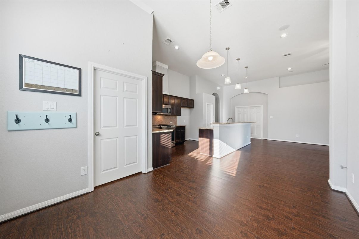 Empty room, Interior, Kitchen, Pendant Lights, Recessed Lighting, Stainless Steel Appliances, Wood Texture Flooring