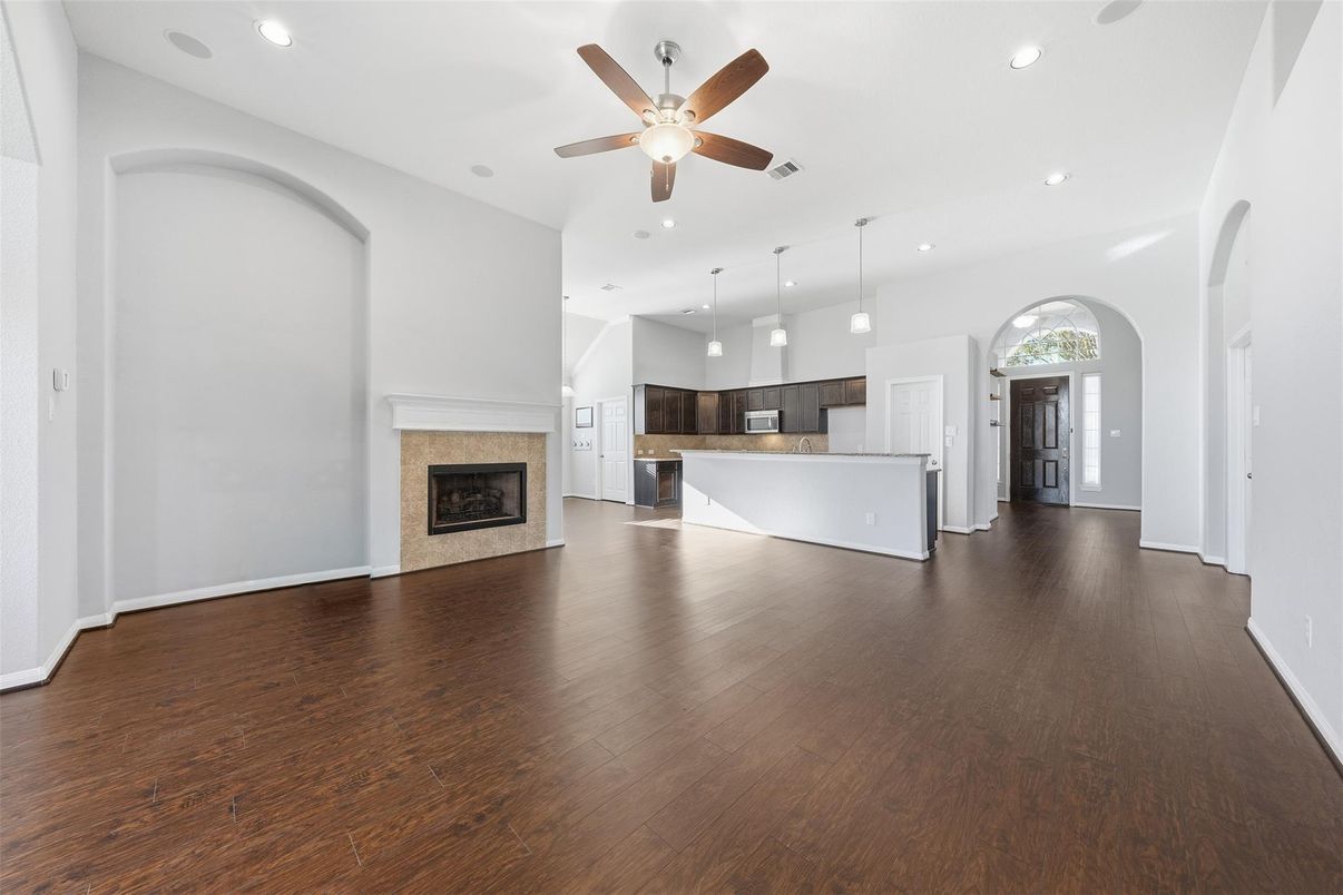Empty room, Fireplace, Interior, Kitchen, Pendant Lights, Recessed Lighting, Wood Texture Flooring