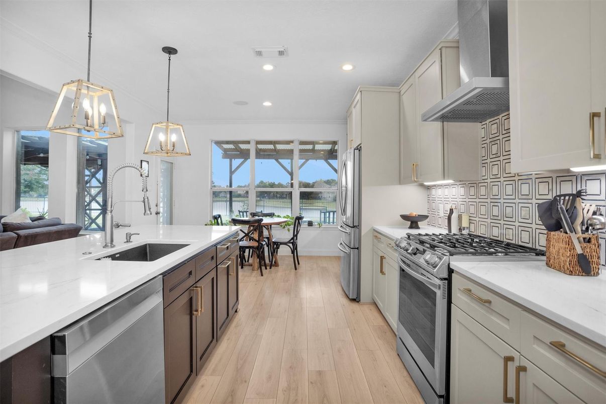 Dining room, Interior, Kitchen, Pendant Lights, Recessed Lighting, Stainless Steel Appliances, Water, Wood Texture Flooring