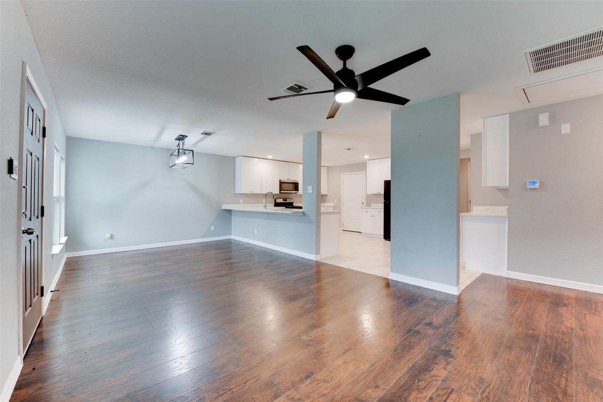 Empty room, Interior, Kitchen, Pendant Lights, Recessed Lighting, Stainless Steel Appliances, Wood Texture Flooring