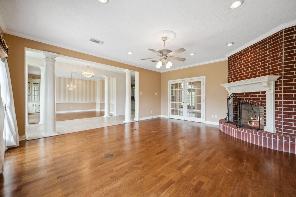 Chandelier, Empty room, Fireplace, Interior, Recessed Lighting, Stone Walls, Wood Texture Flooring