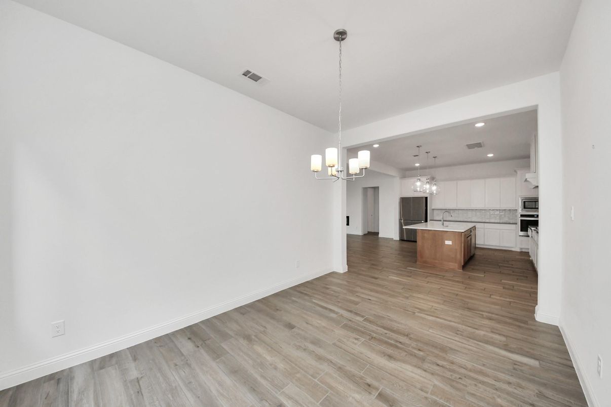 Chandelier, Empty room, Interior, Kitchen, Pendant Lights, Recessed Lighting, Stainless Steel Appliances, Wood Texture Flooring