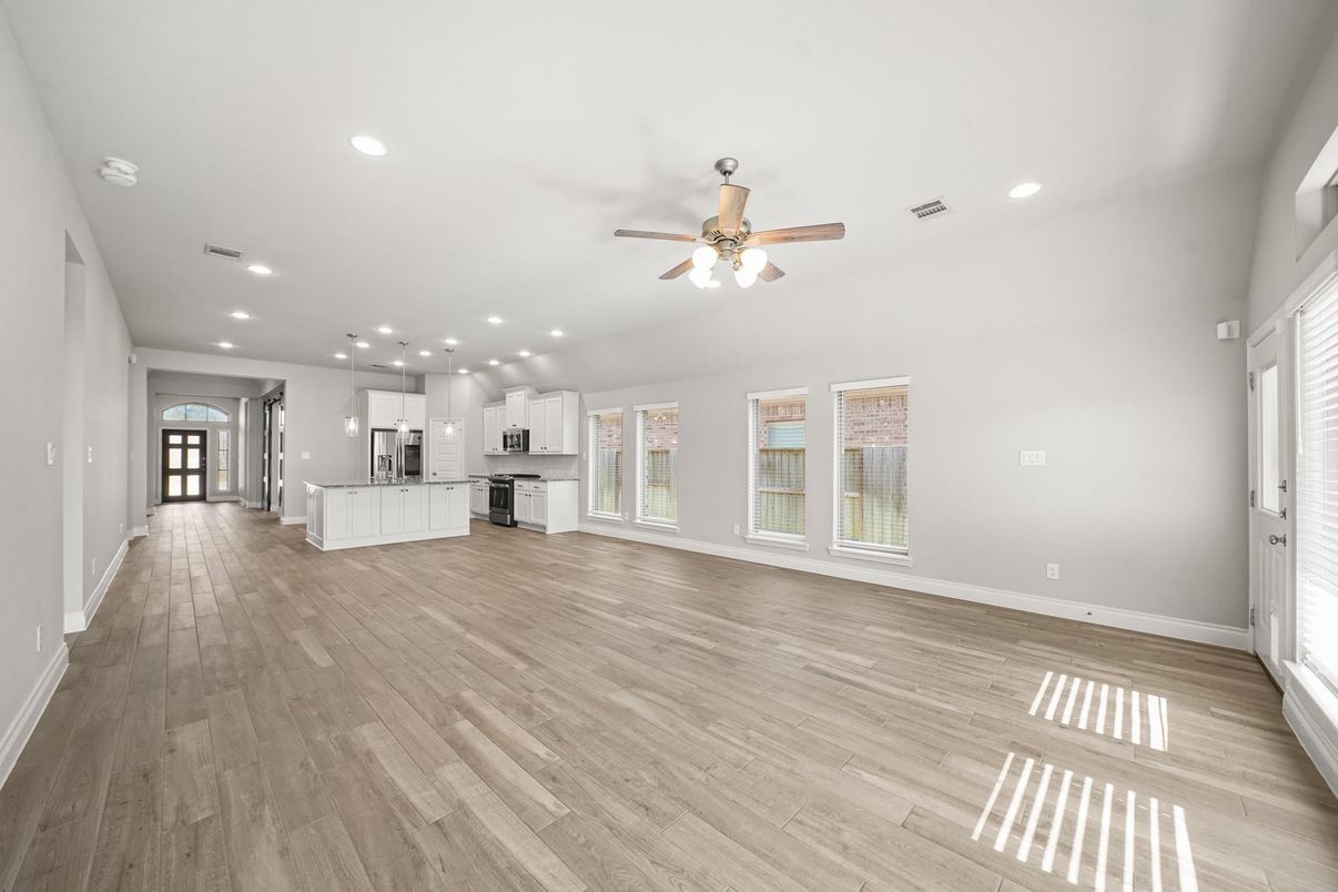 Empty room, Interior, Kitchen, Recessed Lighting, Stainless Steel Appliances, Wood Texture Flooring