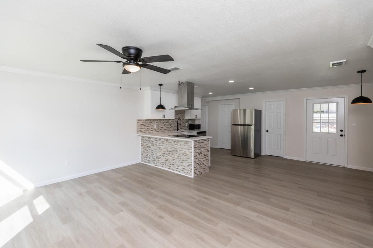 Empty room, Interior, Kitchen, Pendant Lights, Recessed Lighting, Stainless Steel Appliances, Wood Texture Flooring