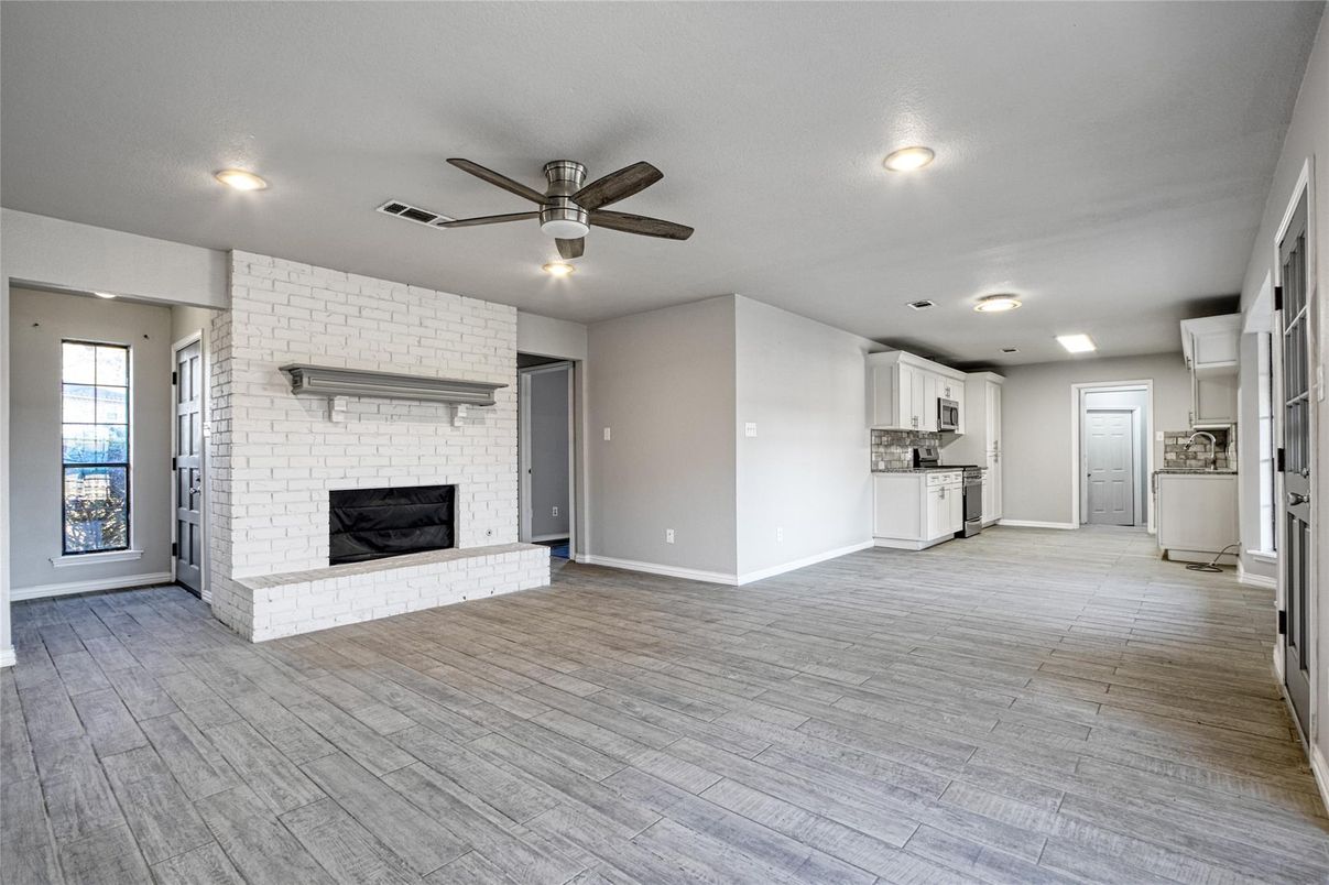 Empty room, Fireplace, Interior, Kitchen, Recessed Lighting, Stone Walls, Wood Texture Flooring