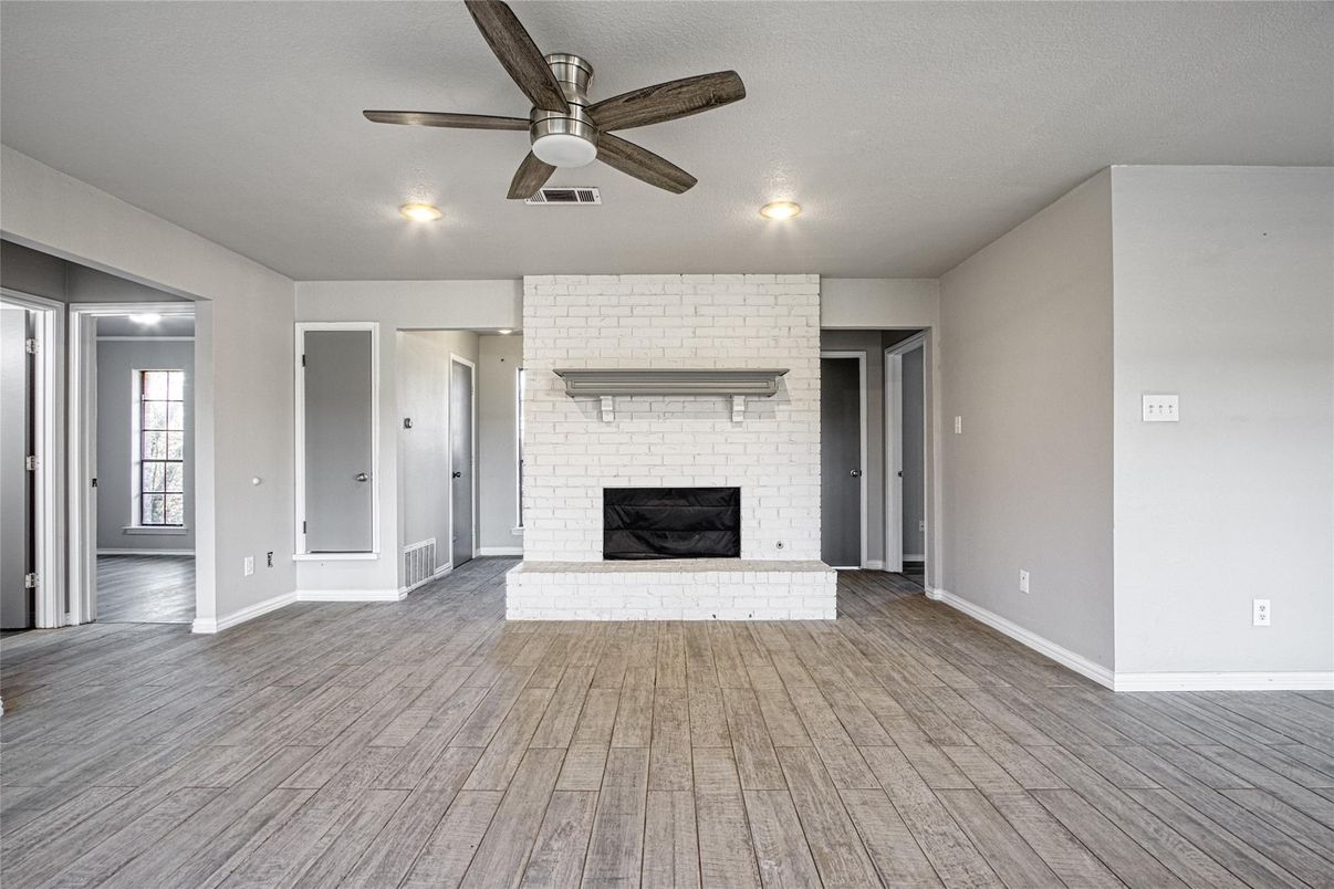 Empty room, Fireplace, Interior, Recessed Lighting, Stone Walls, Wood Texture Flooring