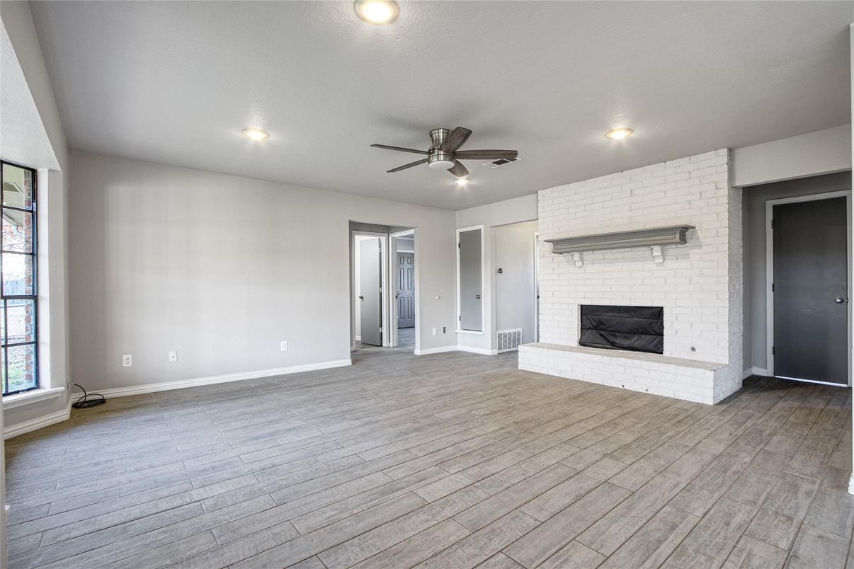 Empty room, Fireplace, Interior, Recessed Lighting, Stone Walls, Wood Texture Flooring