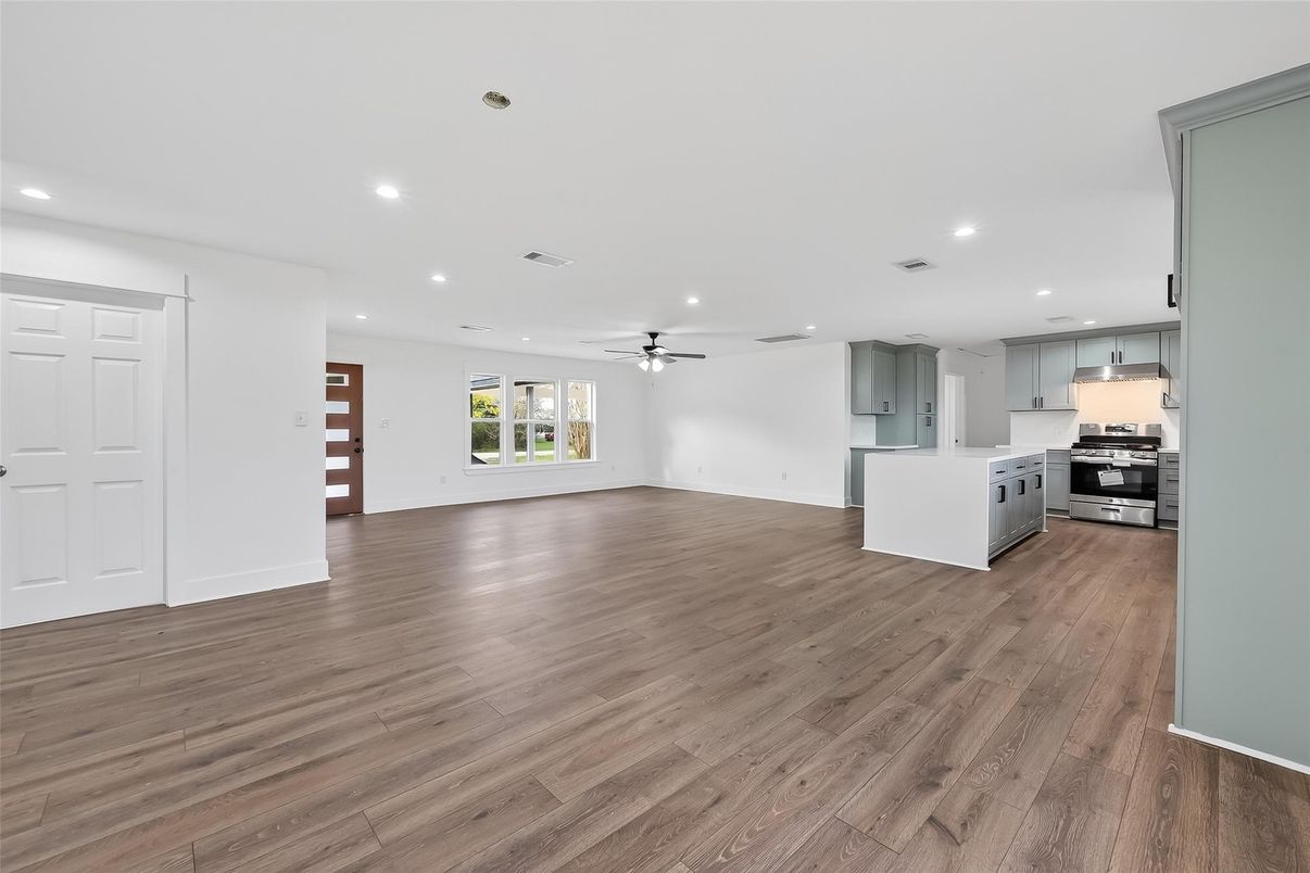 Empty room, Interior, Kitchen, Recessed Lighting, Stainless Steel Appliances, Wood Texture Flooring