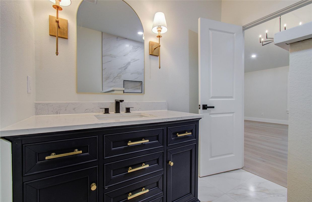 Bathroom, Dual Sink Vanities, Interior, Marble, Marble Walls, Recessed Lighting, Wood Texture Flooring