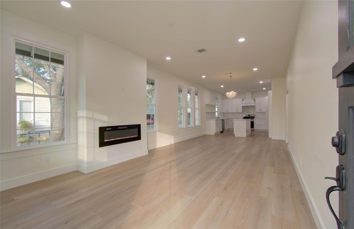 Empty room, Fireplace, Interior, Kitchen, Pendant Lights, Recessed Lighting, Wood Texture Flooring
