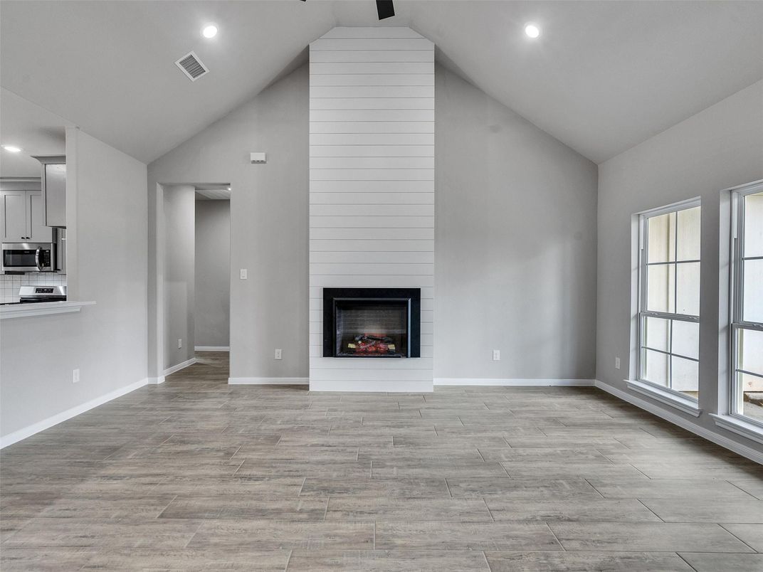 Empty room, Fireplace, Interior, Kitchen, Recessed Lighting, Wood Texture Flooring