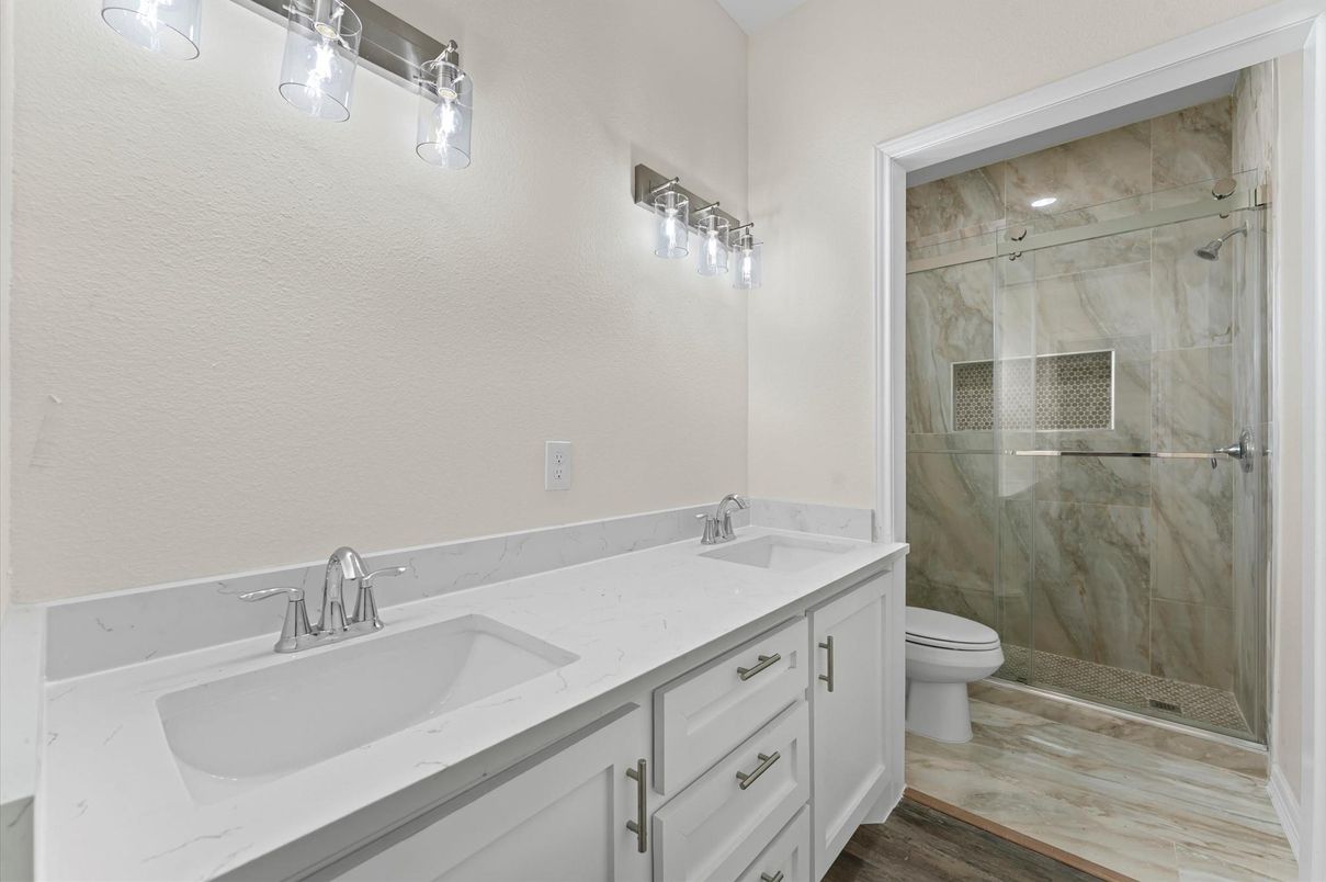 Bathroom, Dual Sink Vanities, Glass Shower, Interior, Marble Walls, Wood Texture Flooring