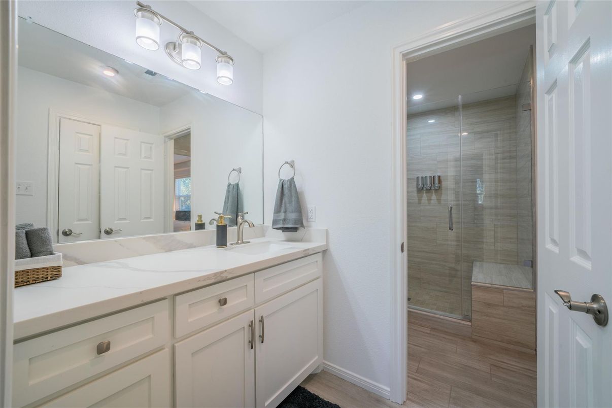 Bathroom, Dual Sink Vanities, Glass Shower, Interior, Recessed Lighting, Wood Texture Flooring