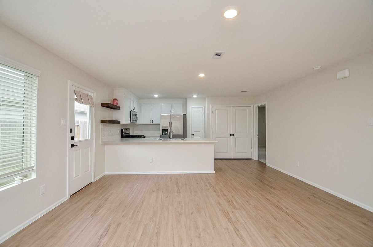 Empty room, Interior, Kitchen, Recessed Lighting, Stainless Steel Appliances, Wood Texture Flooring