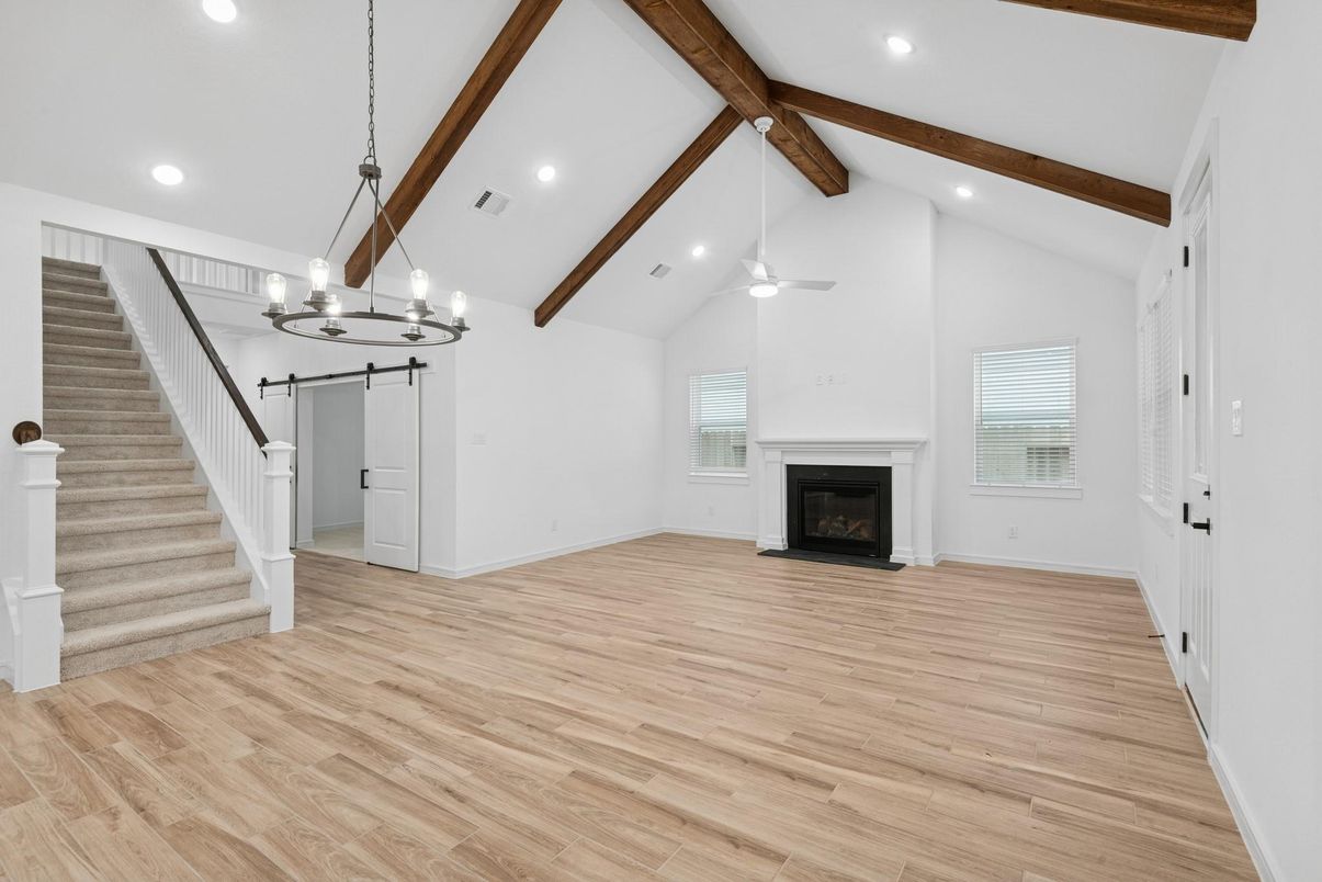 Chandelier, Empty room, Fireplace, Interior, Recessed Lighting, Wooden Beams, Wood Texture Flooring