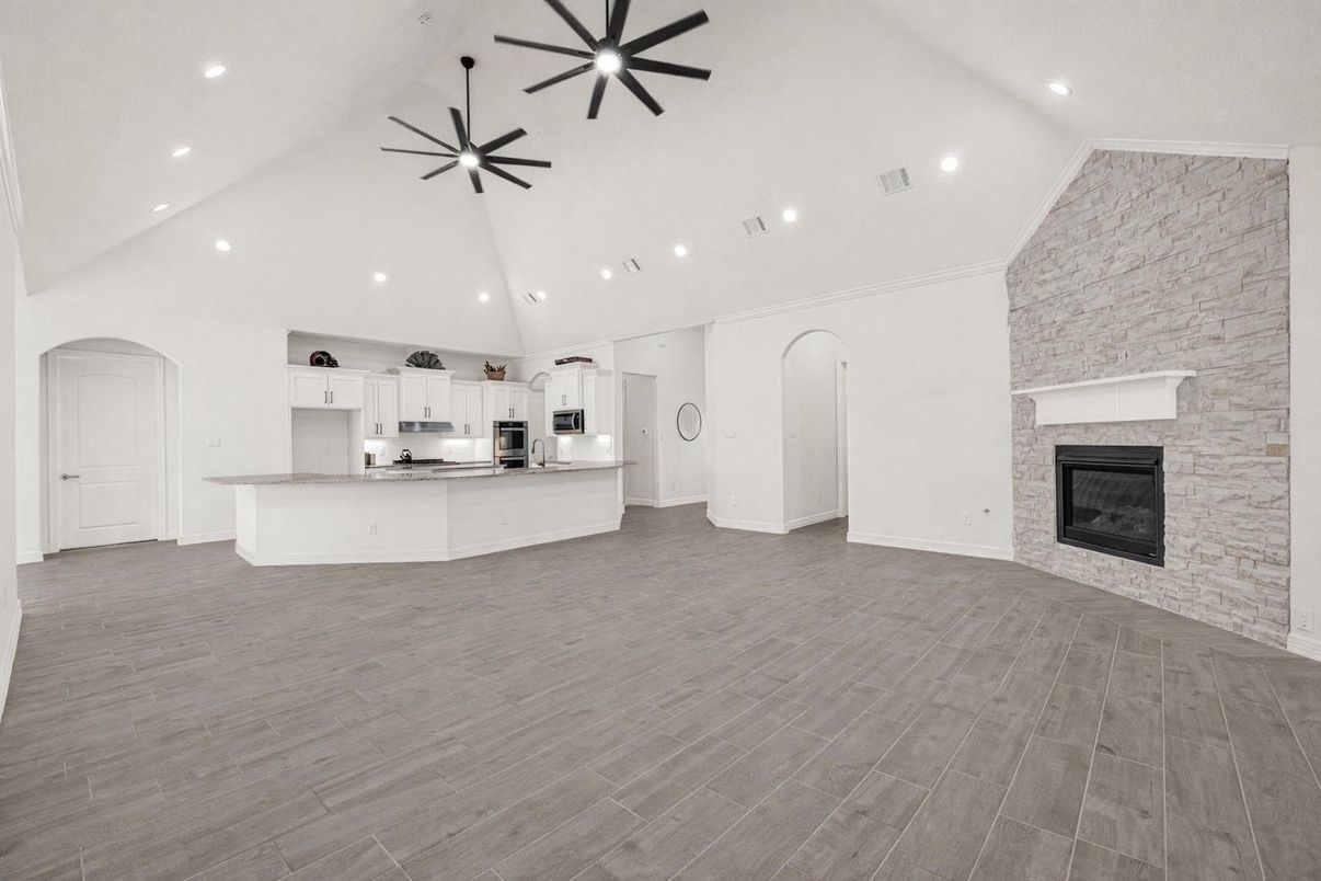 Empty room, Fireplace, Interior, Kitchen, Pendant Lights, Recessed Lighting, Stainless Steel Appliances, Stone Walls, Wood Texture Flooring