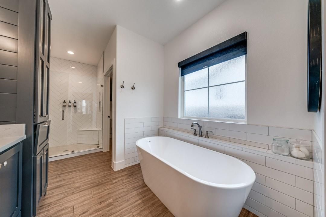 Bathroom, Free Standing Baths, Glass Shower, Interior, Recessed Lighting, Wood Texture Flooring