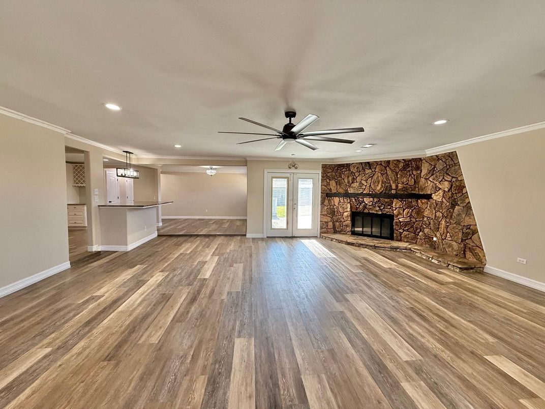 Empty room, Fireplace, Interior, Pendant Lights, Recessed Lighting, Stone Walls, Wood Texture Flooring