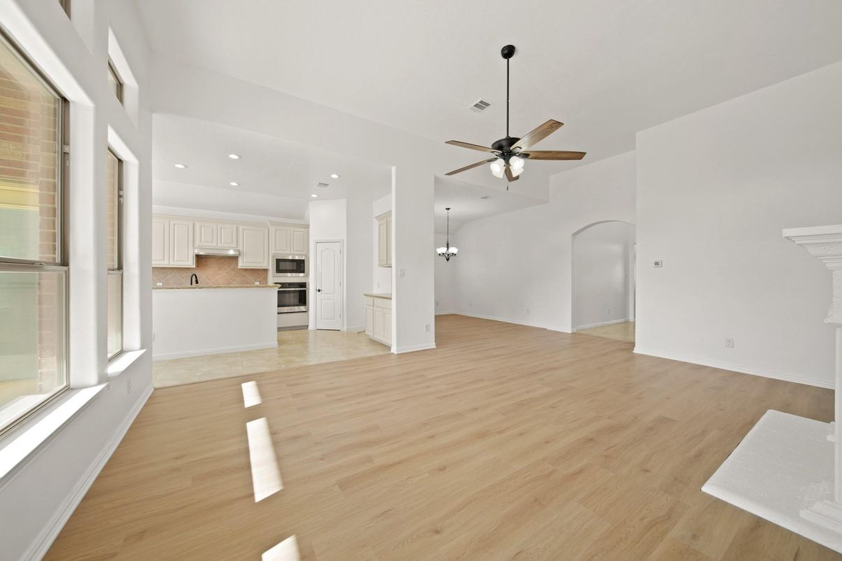 Empty room, Interior, Kitchen, Recessed Lighting, Stainless Steel Appliances, Wood Texture Flooring