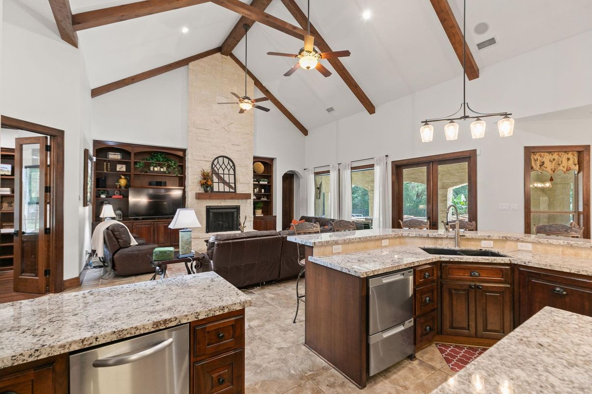 Fireplace, Interior, Kitchen, Living room, Pendant Lights, Recessed Lighting, Stainless Steel Appliances, Stone Walls, Wooden Beams