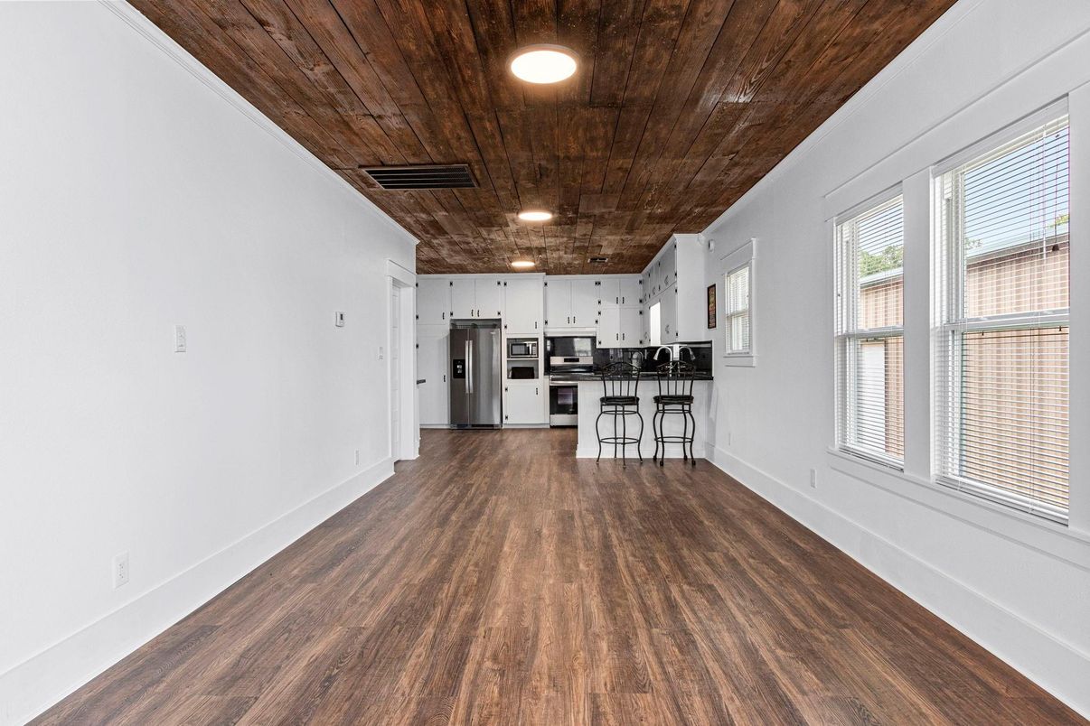 Empty room, Interior, Kitchen, Recessed Lighting, Stainless Steel Appliances, Wooden Ceilings, Wood Texture Flooring