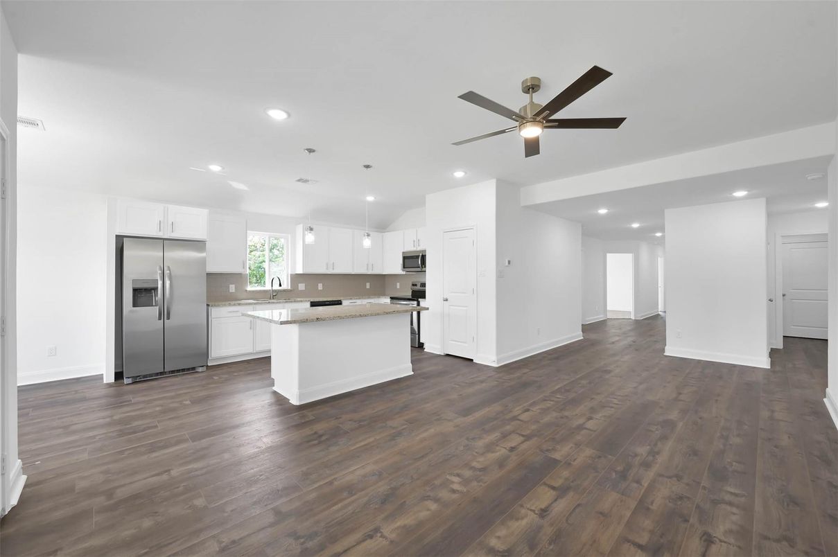 Empty room, Interior, Kitchen, Recessed Lighting, Stainless Steel Appliances, Wood Texture Flooring