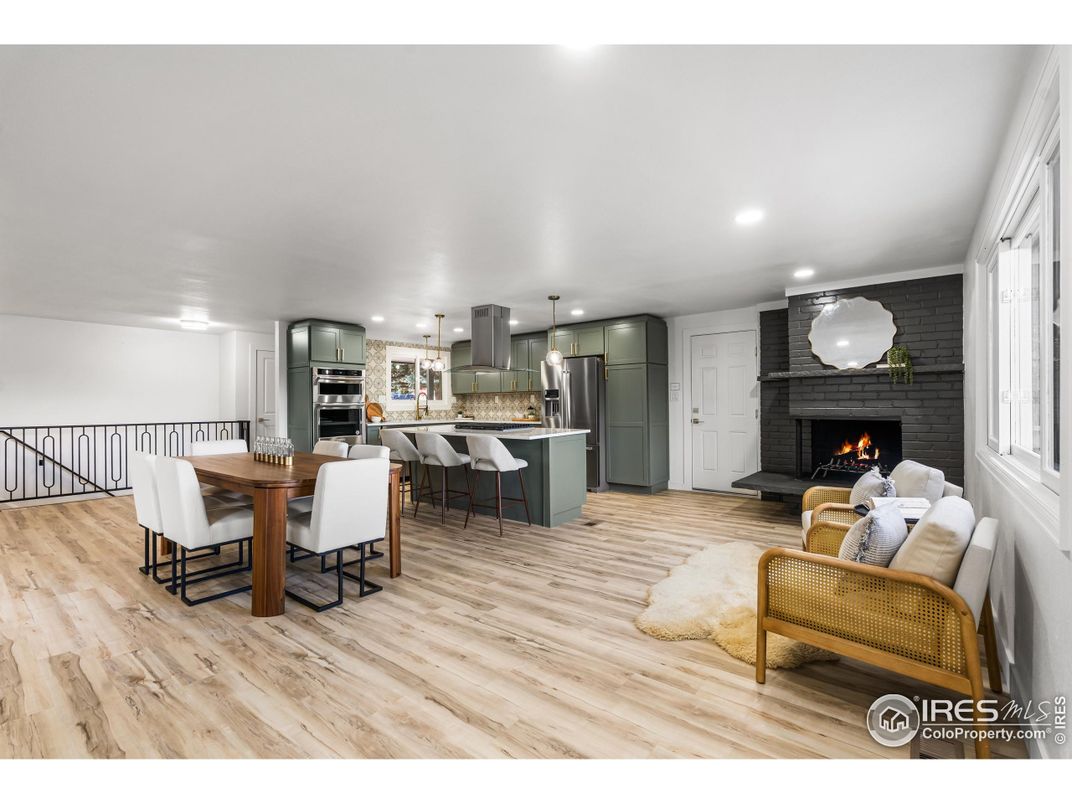 Dining room, Fireplace, Interior, Kitchen, Pendant Lights, Recessed Lighting, Stainless Steel Appliances, Stone Walls, Wood Texture Flooring