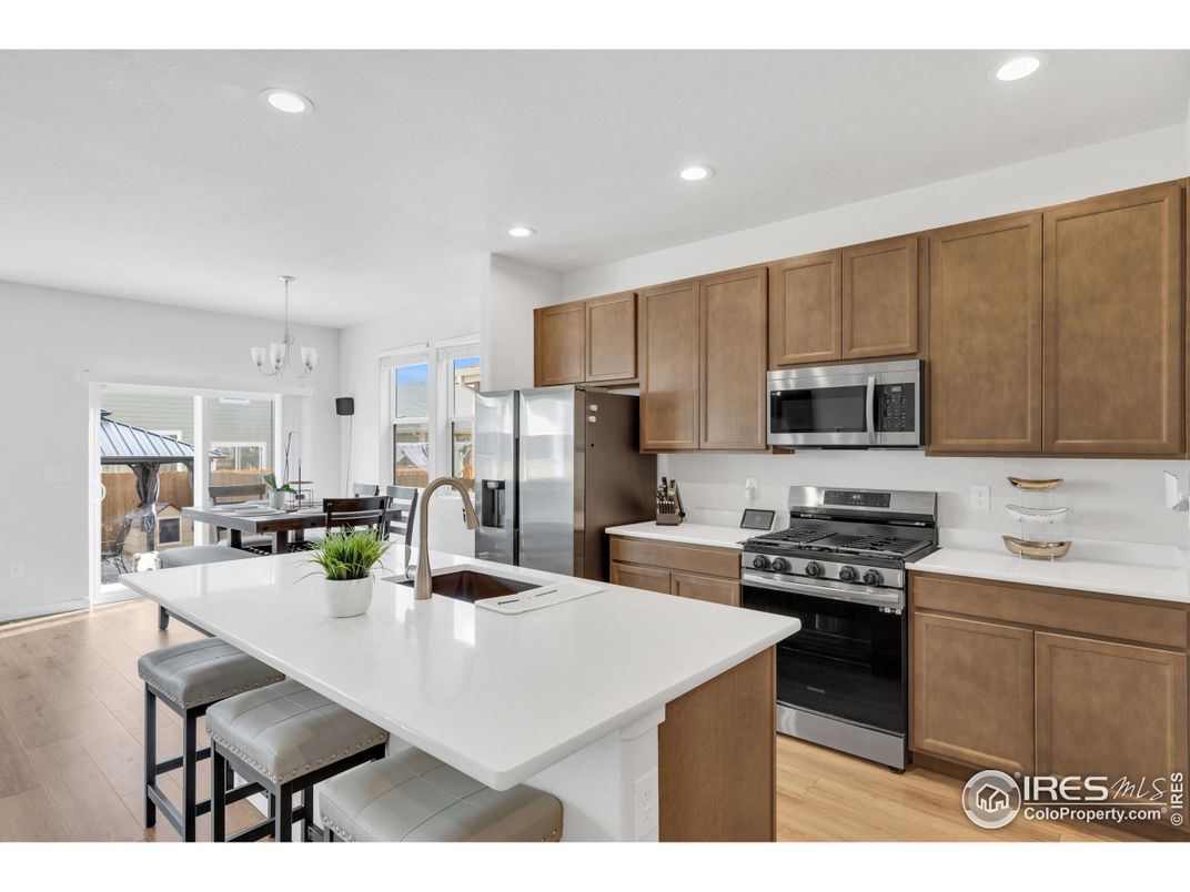 Chandelier, Dining room, Interior, Kitchen, Recessed Lighting, Stainless Steel Appliances, Wood Texture Flooring