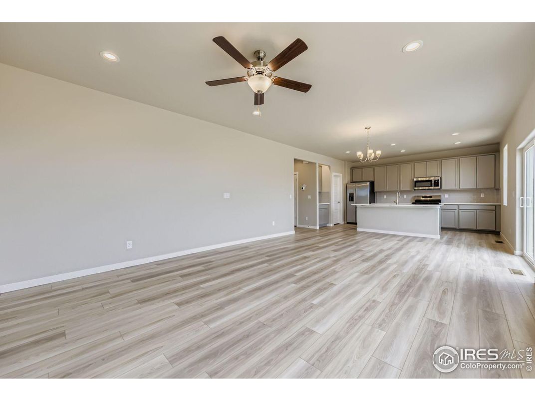 Chandelier, Empty room, Interior, Kitchen, Recessed Lighting, Stainless Steel Appliances, Wood Texture Flooring