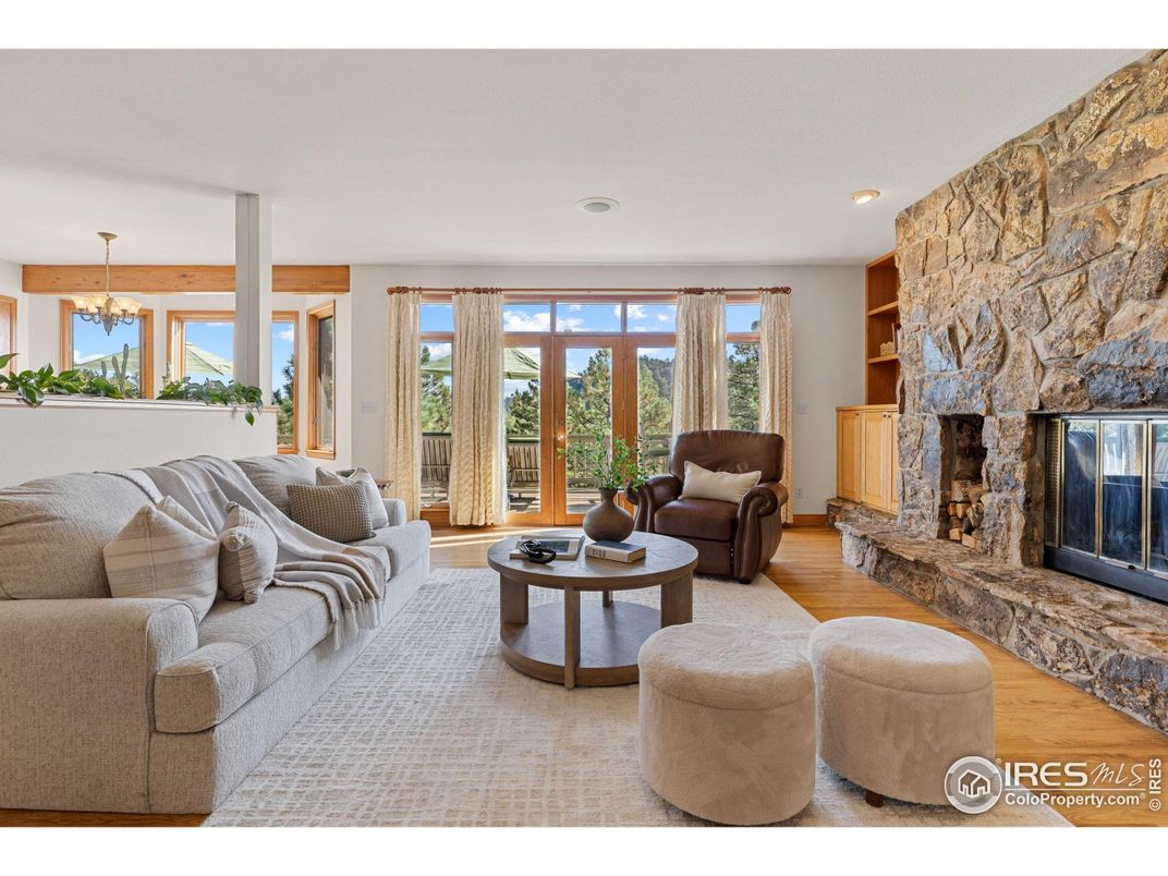 Chandelier, Fireplace, Interior, Living room, Recessed Lighting, Stone Walls, Wood Texture Flooring