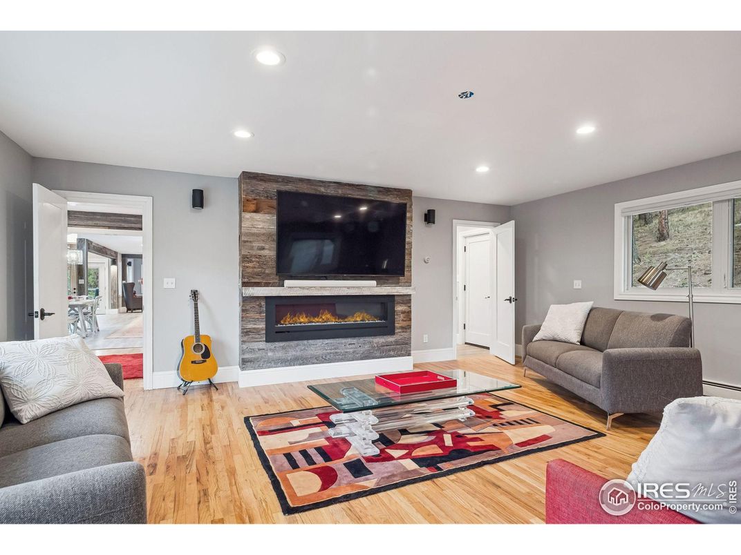 Fireplace, Interior, Living room, Recessed Lighting, Stone Walls, Wood Texture Flooring