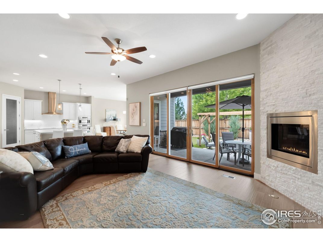 Fireplace, Interior, Kitchen, Living room, Pendant Lights, Recessed Lighting, Stainless Steel Appliances, Stone Walls, Wood Texture Flooring