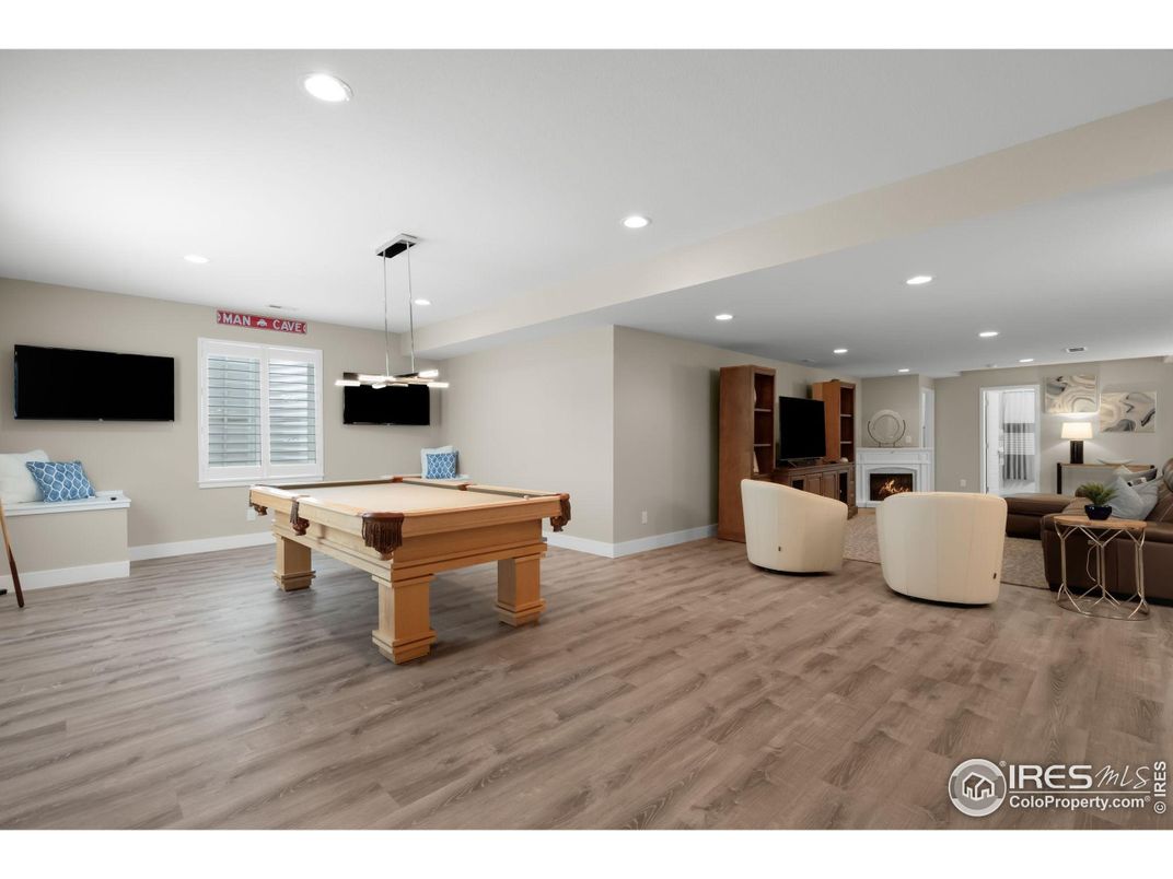 Billiard Table, Fireplace, Game Room, Interior, Living room, Pendant Lights, Recessed Lighting, Wood Texture Flooring