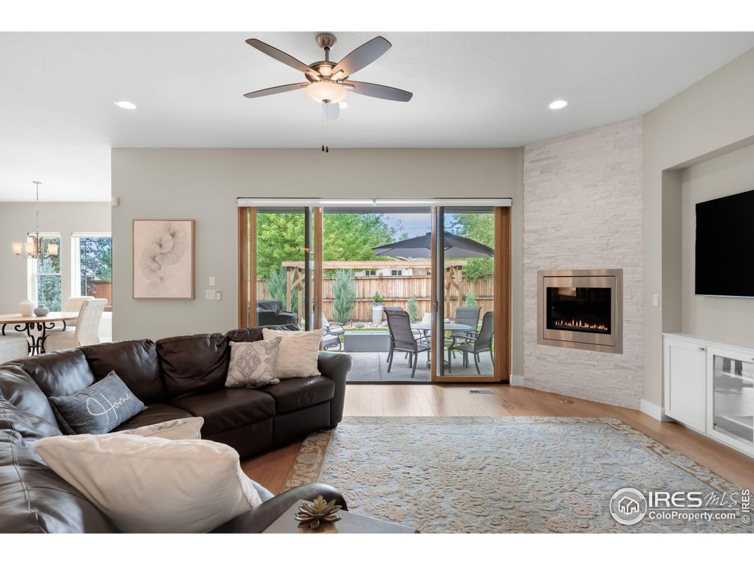 Dining room, Fireplace, Interior, Living room, Recessed Lighting, Stone Walls, Wood Texture Flooring