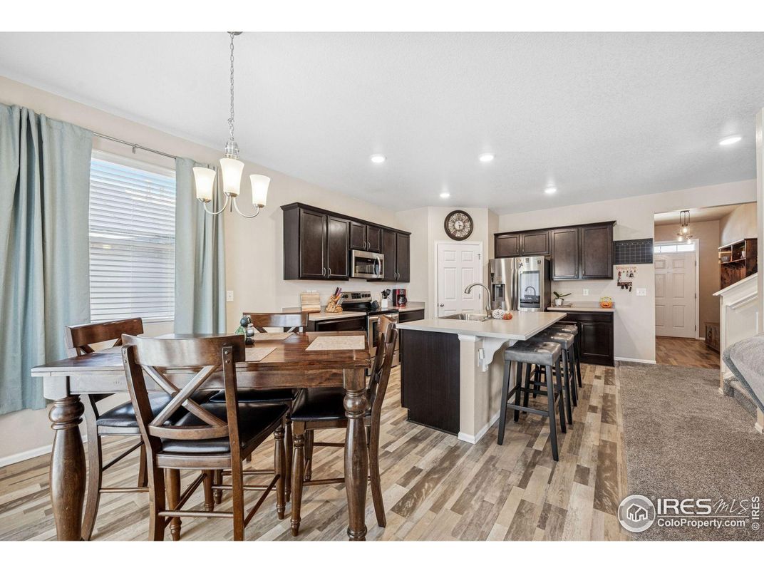 Chandelier, Dining room, Interior, Kitchen, Pendant Lights, Recessed Lighting, Stainless Steel Appliances, Wood Texture Flooring