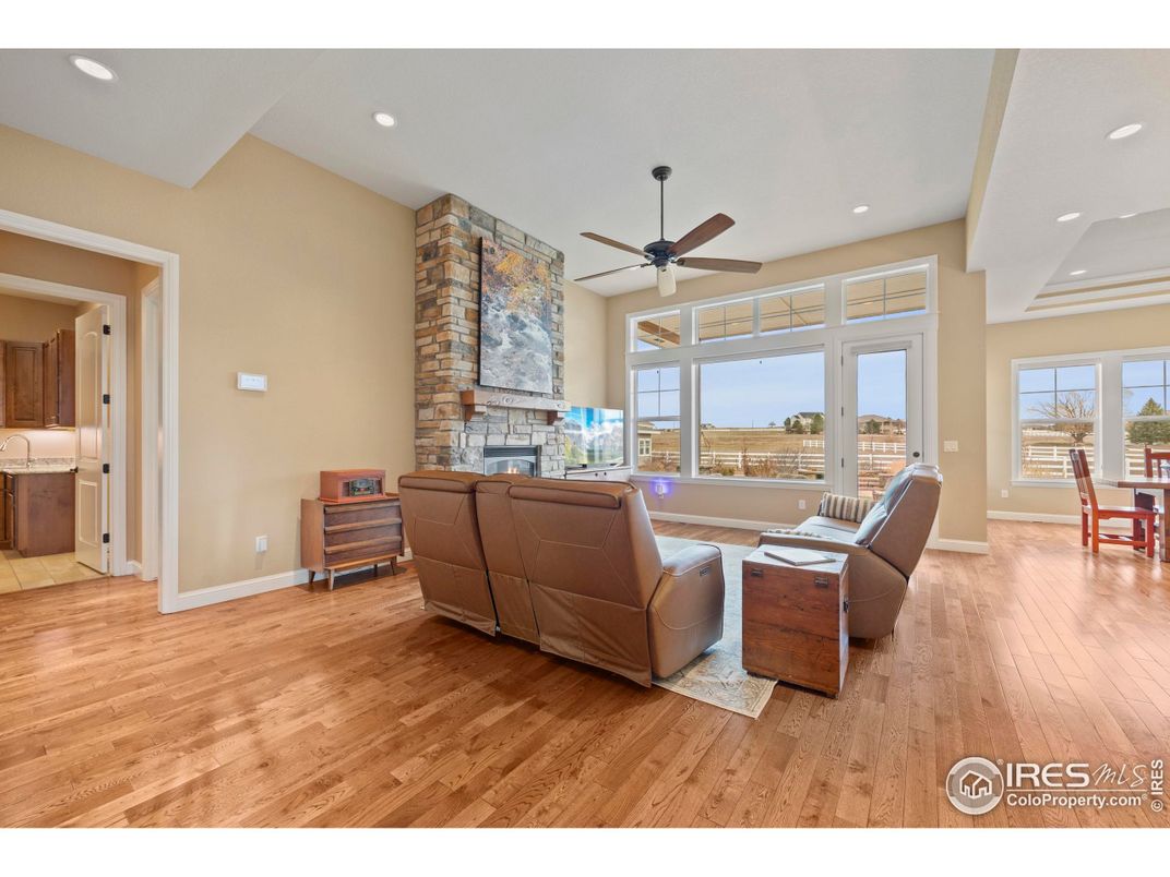 Dining room, Fireplace, Interior, Living room, Recessed Lighting, Stone Walls, Wood Texture Flooring