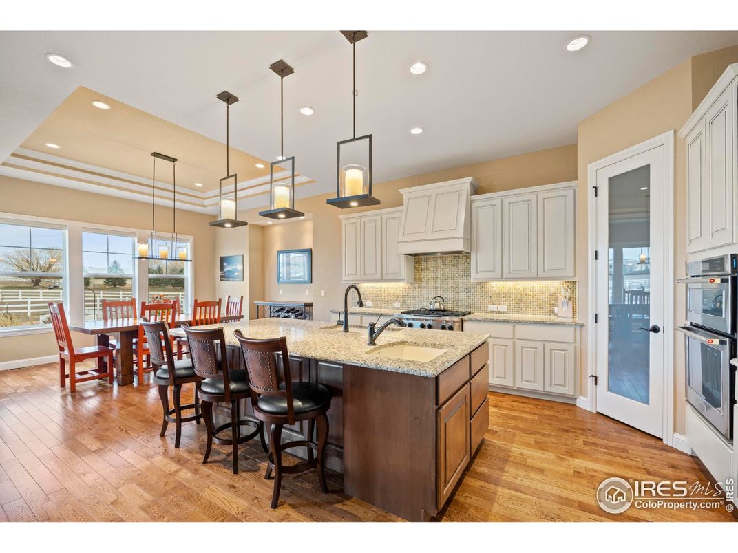 Dining room, Interior, Kitchen, Pendant Lights, Recessed Lighting, Stainless Steel Appliances, Wood Texture Flooring