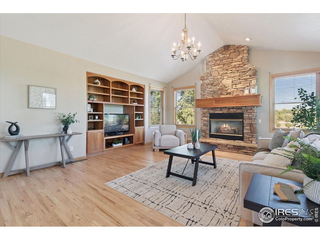 Chandelier, Fireplace, Interior, Living room, Recessed Lighting, Stone Walls, Wood Texture Flooring