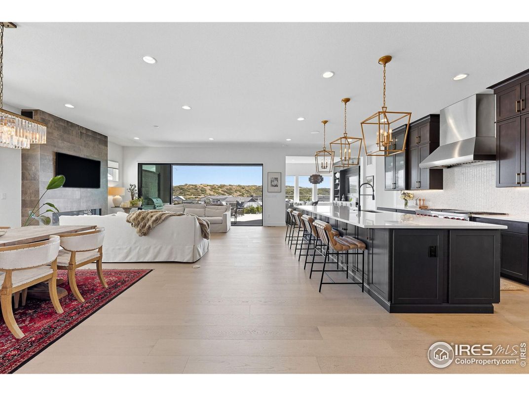 Chandelier, Dining room, Interior, Kitchen, Living room, Pendant Lights, Recessed Lighting, Stainless Steel Appliances, Wood Texture Flooring