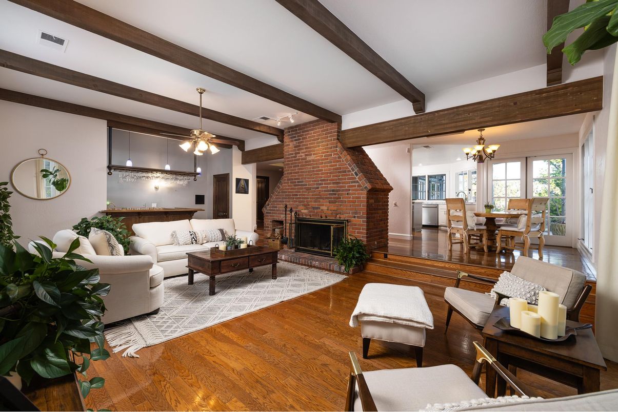 Chandelier, Dining room, Fireplace, Interior, Living room, Pendant Lights, Stone Walls, Wooden Beams, Wood Texture Flooring