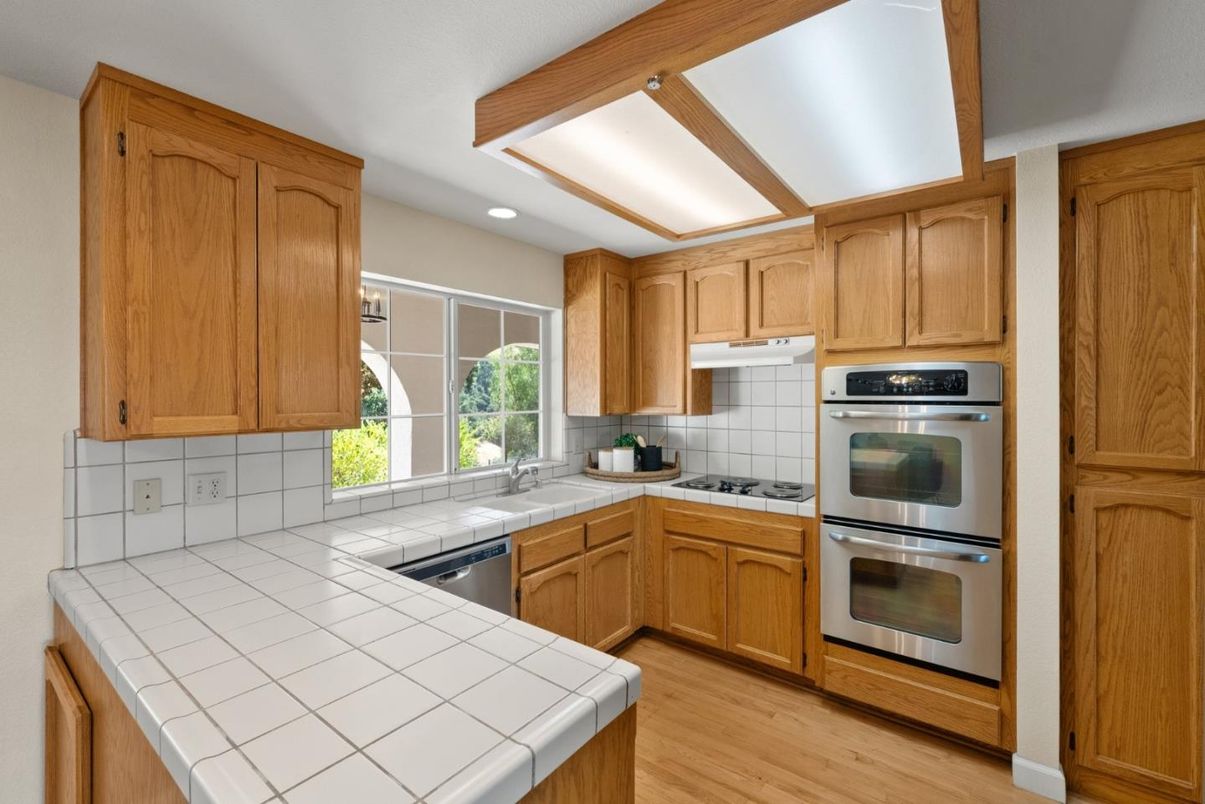 Interior, Kitchen, Recessed Lighting, Stainless Steel Appliances, Tile Countertops, Wood Texture Flooring