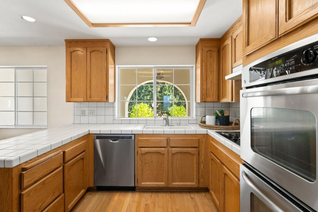 Interior, Kitchen, Recessed Lighting, Stainless Steel Appliances, Tile Countertops, Wood Texture Flooring
