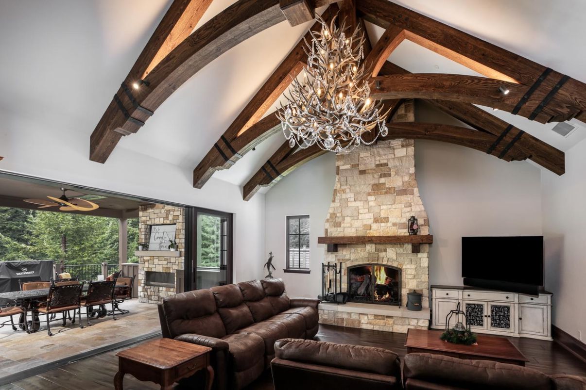 Chandelier, Dining room, Fireplace, Interior, Living room, Stone Walls, Wooden Beams, Wood Texture Flooring
