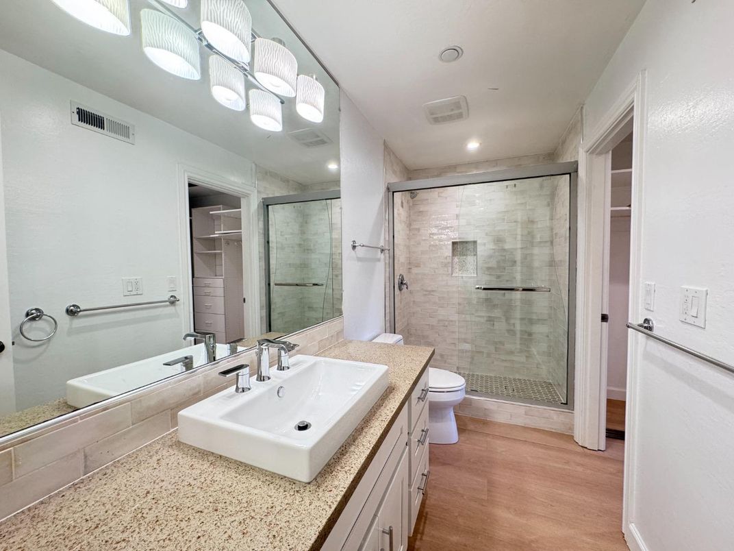 Bathroom, Dual Sink Vanities, Glass Shower, Interior, Recessed Lighting, Wood Texture Flooring