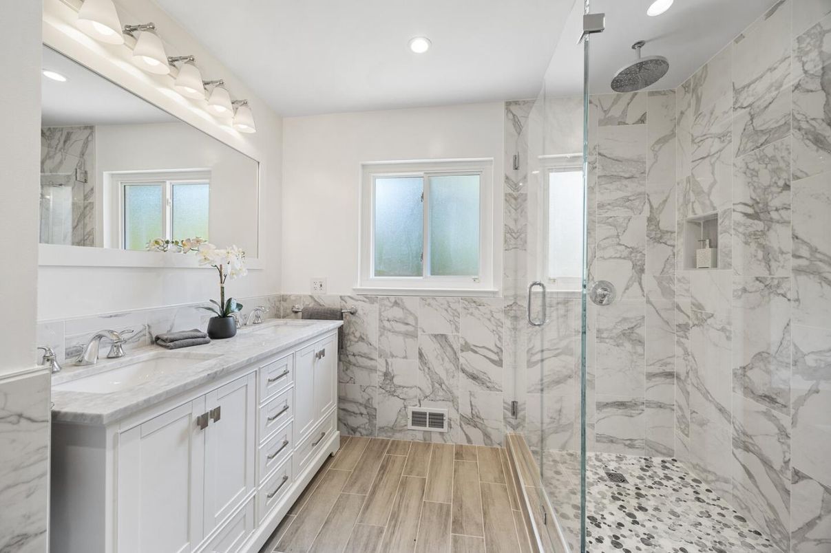Bathroom, Dual Sink Vanities, Glass Shower, Interior, Marble Walls, Recessed Lighting, Wood Texture Flooring