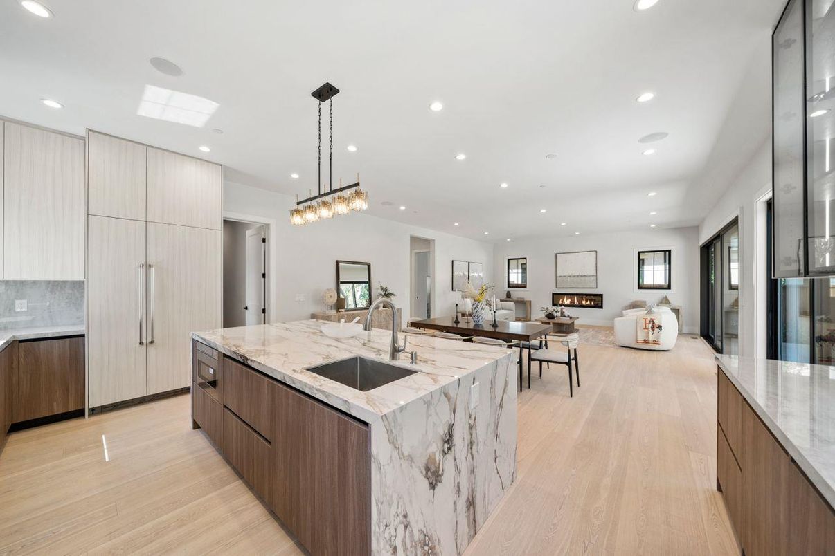 Fireplace, Interior, Kitchen, Living room, Pendant Lights, Recessed Lighting, Stainless Steel Appliances, Wood Texture Flooring